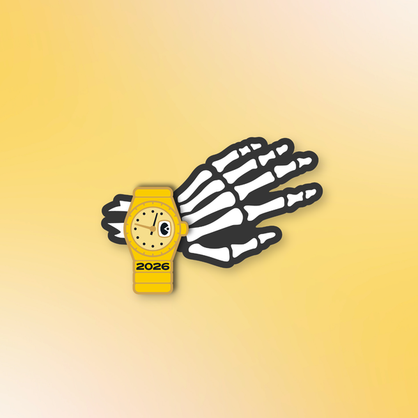A novelty enamel pin of a wristwatch with the year 2026 engraved on it, set on the wrist of a skeletal hand.